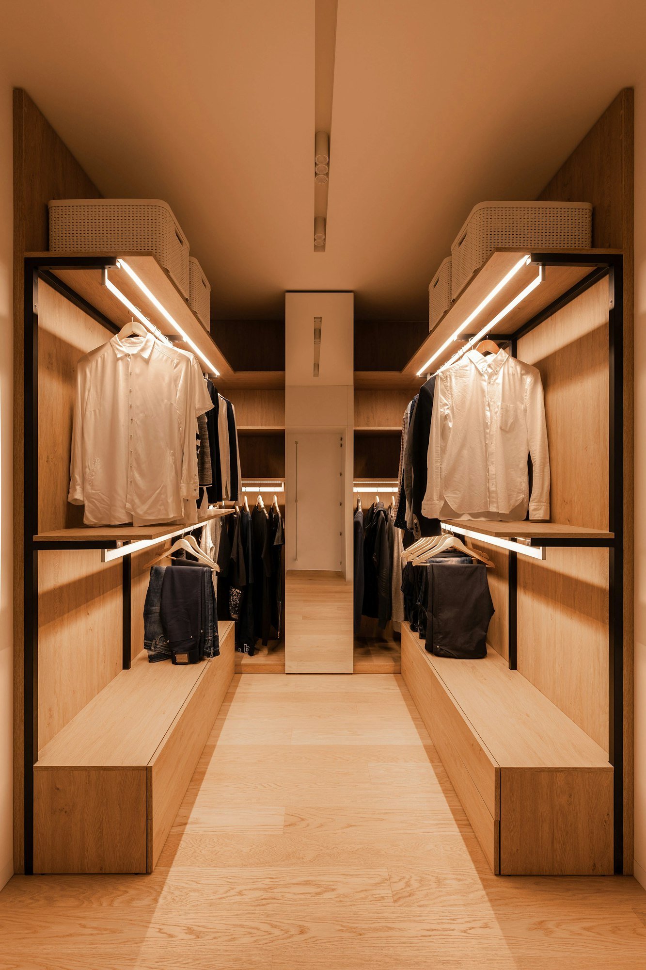 Un dressing en chêne, avec des éclairages intégrés aux étagères