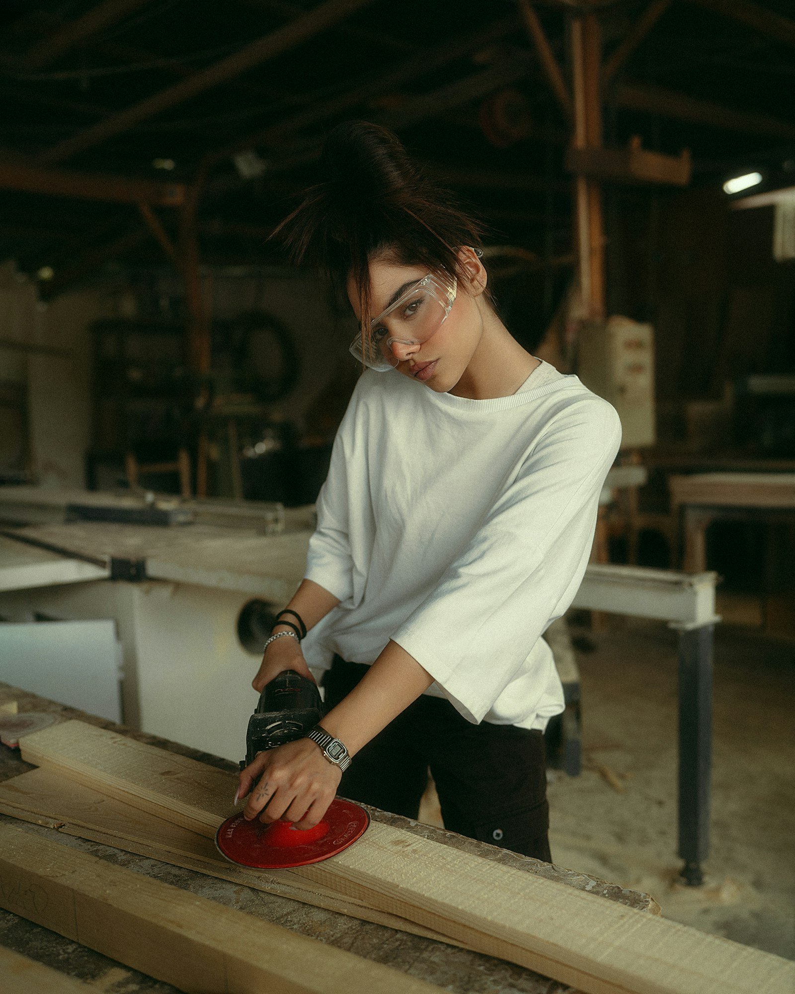 Lina sanding an oak board before finishing